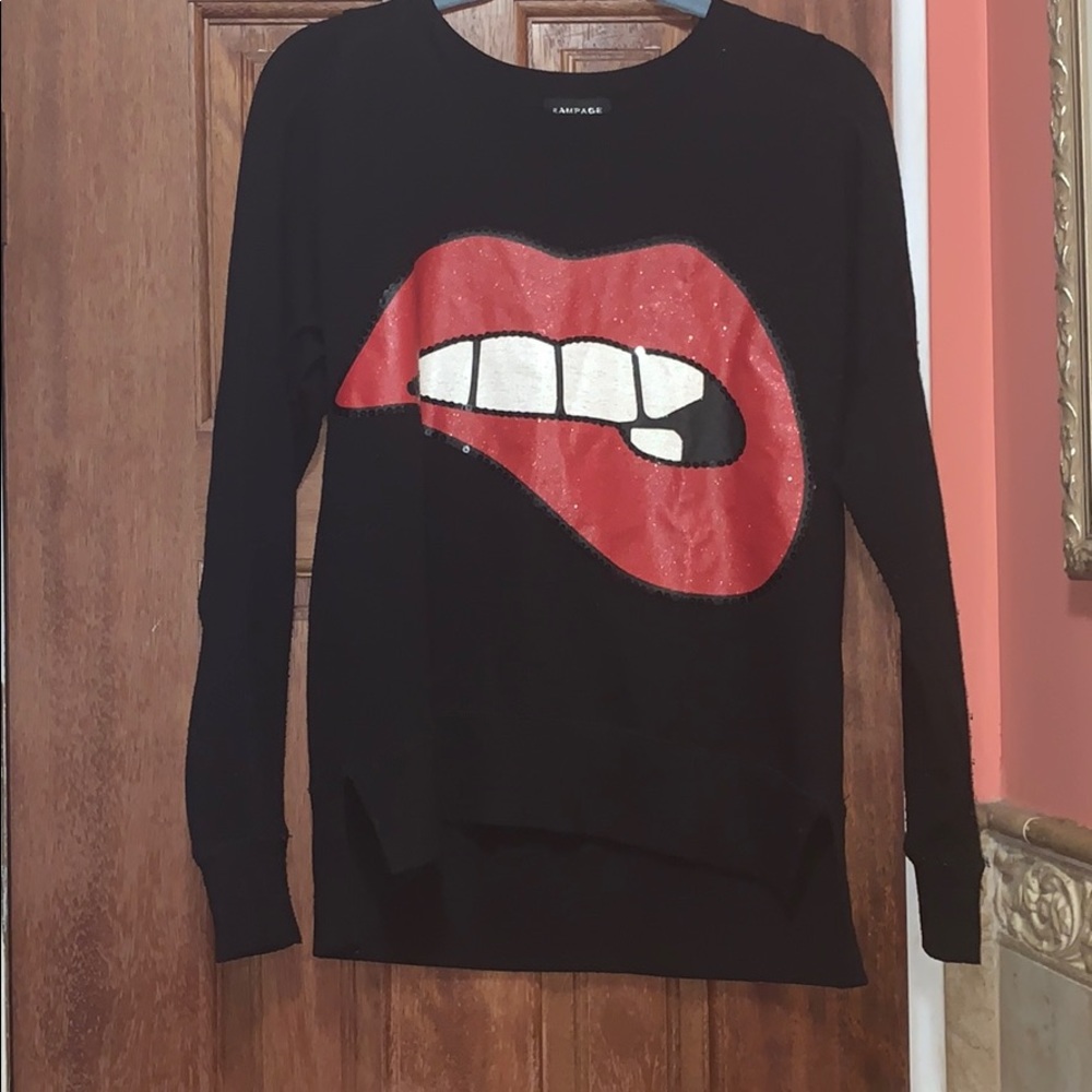 Black sweater with lip bitting design.
